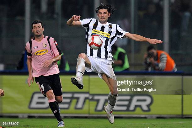 Vincenzo Iaquinta of Juventus in action as Cesare Bovo of Palermo looks on during the Serie A match played between US Citta di Palermo and Juventus...