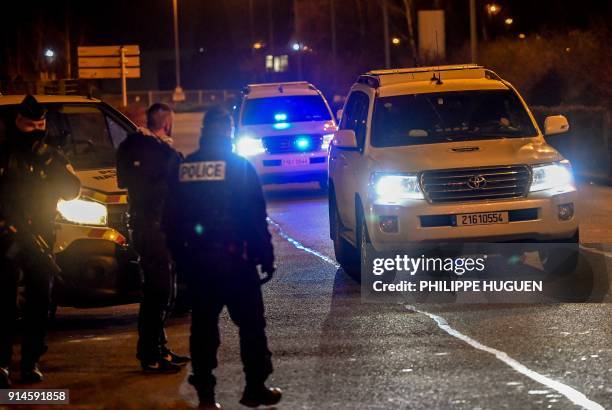 Police stand guard on the side of the road as a convoy understood to be transporting the only surviving suspect in the November 2015 Paris attacks,...