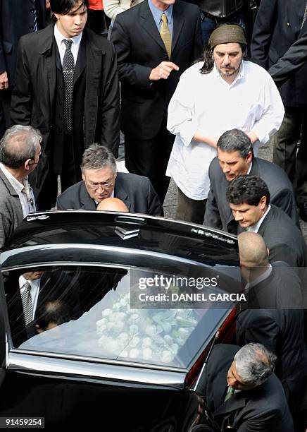 Fabian Matus , son of Argentine singer Mercedes Sosa, looks at her coffin just before the start of the funeral cortege to the cemetery after the wake...