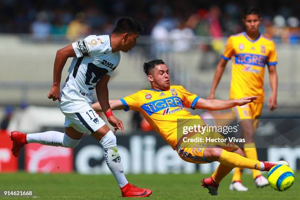 Jesus Gallardo of Pumas struggles for the ball with Israel Jimenez of Tigres during the 5th round match between Pumas UNAM and Tigres UANL as part of...