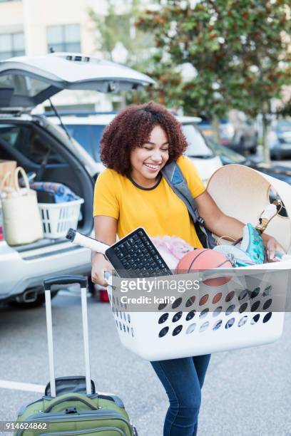 young african-american woman moving house - collegebasket stock pictures, royalty-free photos & images