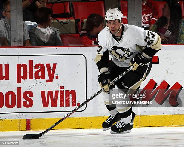 Craig Adams of the Pittsburgh Penguins skates up ice with the puck during a NHL pre-season game against the Detroit Red Wings at Joe Louis Arena on...