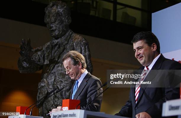 Sigmar Gabriel and outgoing Chairman Franz Muentefering of the German Social Democrats adress the media during a press conference following a meeting...