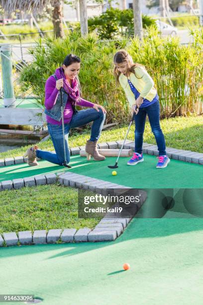 moher and daughter playing miniature golf - mini golf stock pictures, royalty-free photos & images