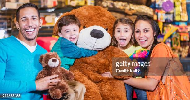 family with prizes in amusement arcade - cas awards stock pictures, royalty-free photos & images