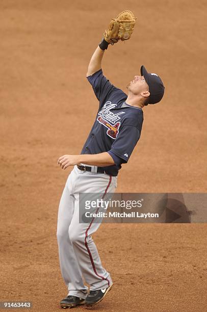Adam LaRoche of the Atlanta Braves fields a pop up during a baseball game against the Washington Nationals on September 27, 2009 at Nationals Park in...