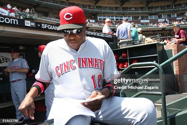 Manager Dusty Baker of the Cincinnati Reds reviews his notes from the dugout during the game against the San Francisco Giants at the AT&T Park in San...