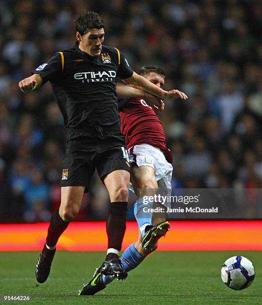 Gareth Barry of Manchester City competes for the ball with James Milner of Aston Villa during the Barclays Premier League match between Aston Villa...