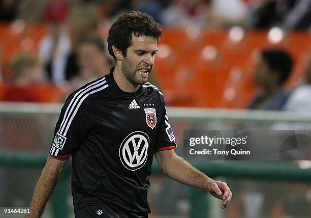 Ben Olsen of D.C. United walks off the field after receiving a red card during an MLS match against Chivas USA at RFK Stadium on October 3, 2009 in...