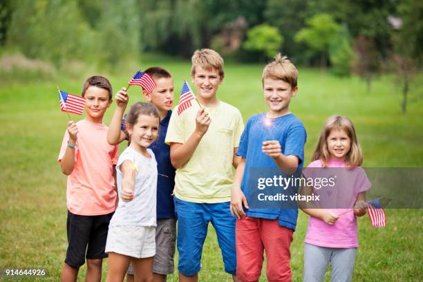 group of children with american flags - 9 11 flag stock pictures, royalty-free photos & images