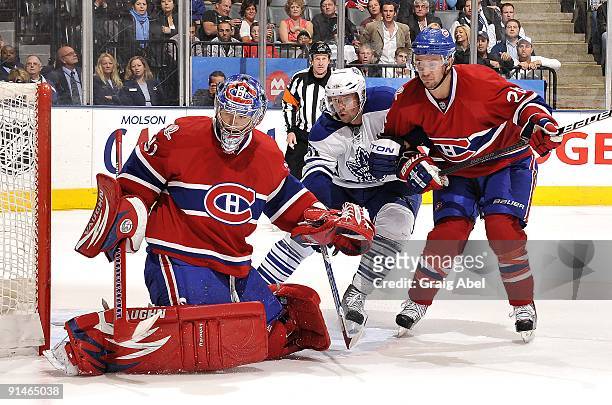 Rickard Wallin of the Toronto Maple Leafs battles for position with Josh Gorges of the Montreal Canadiens in front of goaltender Carey Price of the...