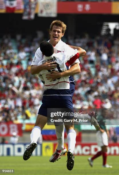 Brian McBride of the USA celebrates his goal with team mate Claudio Reyna during the Mexico v USA, World Cup Second Round match played at the Jeonju...