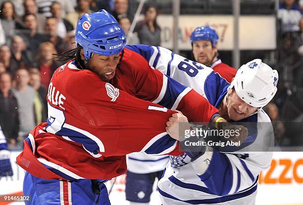 Colton Orr of the Toronto Maple Leafs fights Georges Laraque of the Montreal Canadiens during game action on October 1, 2009 at the Air Canada Centre...