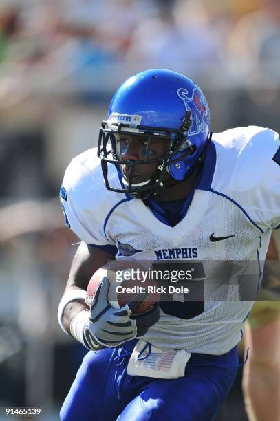 Running back Lance Smith of the Memphis Tigers rushes against the Central Florida Knights at Bright House Networks Stadium on October 3, 2009 in...