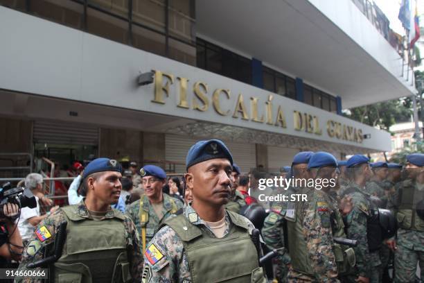 The police stand guard outside the public prosecutor's office in Guayaquil, Ecuador on February 5, 2018 as former Ecuadorian president Rafael Correa...