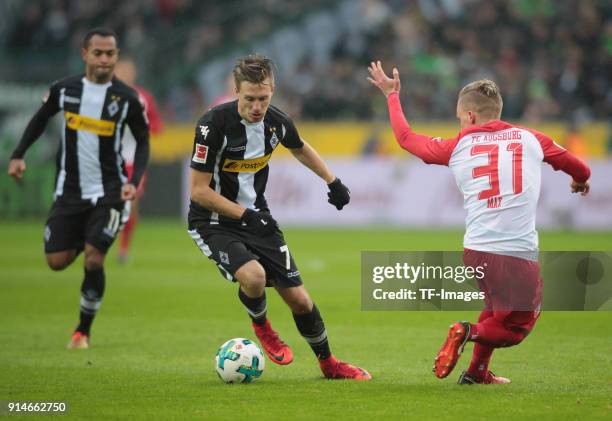 Philipp Max of Augsburg and Patrick Herrmann of Moenchengladbach battle for the ball during the Bundesliga match between Borussia Moenchengladbach...