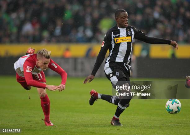 Philipp Max of Augsburg and Denis Zakaria of Moenchengladbach battle for the ball during the Bundesliga match between Borussia Moenchengladbach and...
