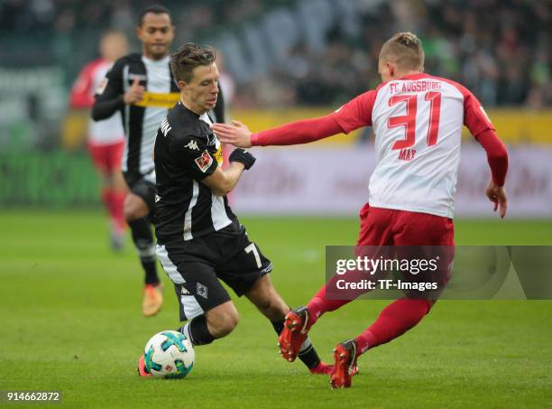 Philipp Max of Augsburg and Patrick Herrmann of Moenchengladbach battle for the ball during the Bundesliga match between Borussia Moenchengladbach...