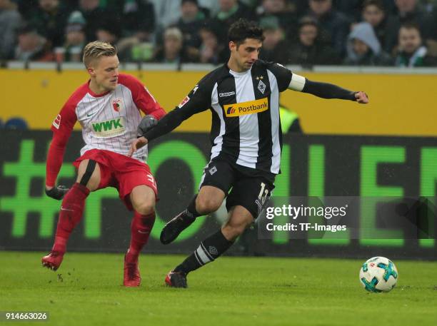 Philipp Max of Augsburg and Lars Stindl of Moenchengladbach battle for the ball during the Bundesliga match between Borussia Moenchengladbach and FC...
