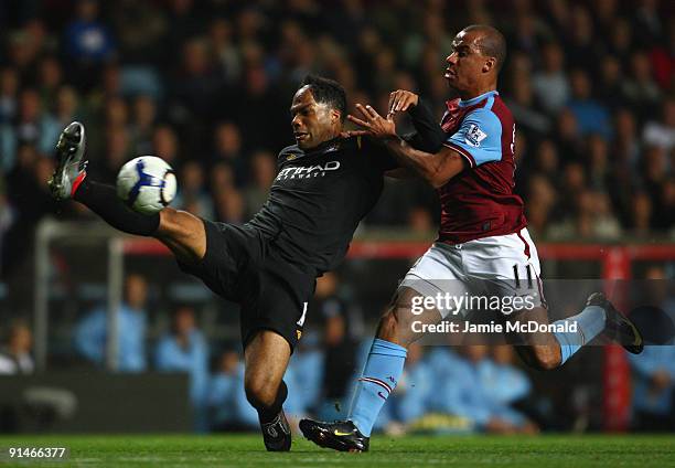 Gabriel Agbonlahor of Aston Villa battles for the ball with Joleon Lescott of Manchester City during the Barclays Premier League match between Aston...