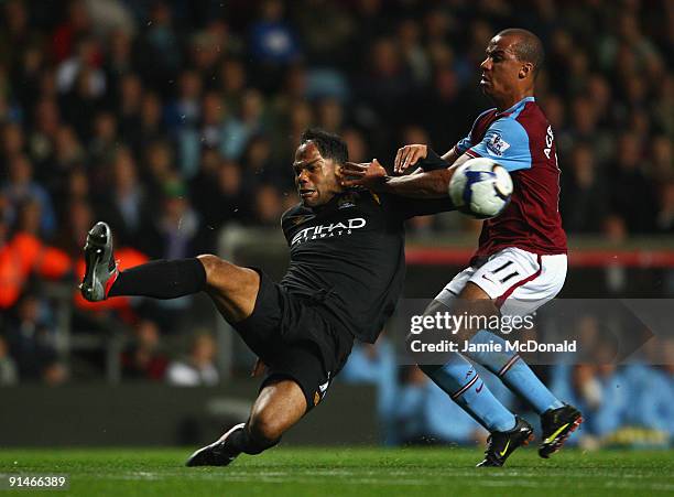 Gabriel Agbonlahor of Aston Villa battles for the ball with Joleon Lescott of Manchester City during the Barclays Premier League match between Aston...