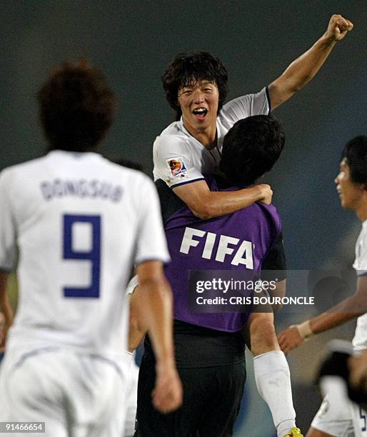 South Korean forward Bo Kyung Kim is carried by a teammate upon the termination of their game against Paraguay of their FIFA U-20 World Cup second...