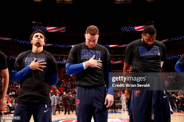 Reggie Hearn Blake Griffin and Andre Drummond of the Detroit Pistons stand for the national anthem prior to the game against the Portland Trail...