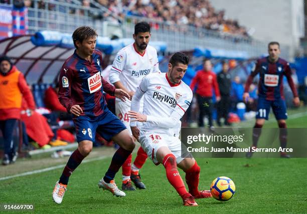 Takashi Inui of SD Eibar duels for the ball with Sergio Escudero of Sevilla FC during the La Liga match between SD Eibar and Sevilla FC at Ipurua...