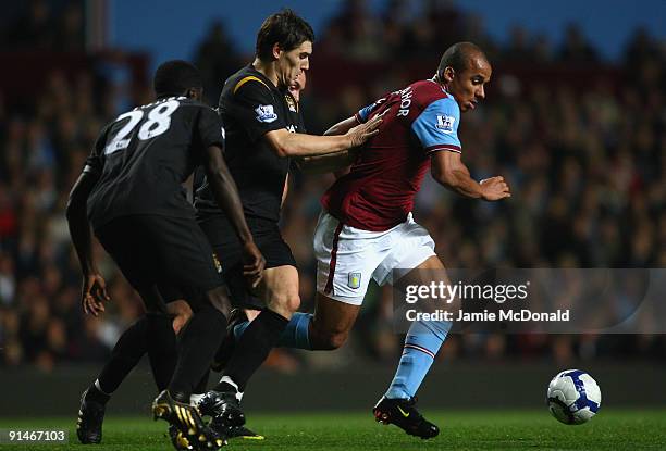 Gareth Barry of Manchester City competes for the ball with Gabriel Agbonlahor of Aston Villa during the Barclays Premier League match between Aston...