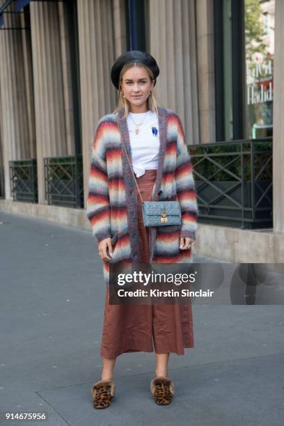 Fashion blogger Nina Suess wears a Dior bag and hat, Chloe cardigan, Tibi trousers and Christian Louboutin shoes day 5 of Paris Womens Fashion Week...