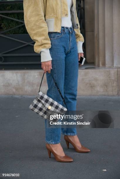 Fashion blogger Adenorah, Anne-Laure Mais wears an Acne jacket, top and shoes, Levi"u2019s jeans, Mansur Gavriel bag day 5 of Paris Womens Fashion...