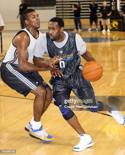 Gilbert Arenas of the Washington Wizards drives against Nick Young during the 2009 NBA Training Camp at the Siegel Center on the campus of Virginia...