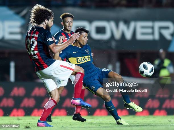 Walter Bou of Boca Juniors fights for ball with Fabricio Coloccini of San Lorenzo during a match between San Lorenzo and Boca Juniors as part of the...