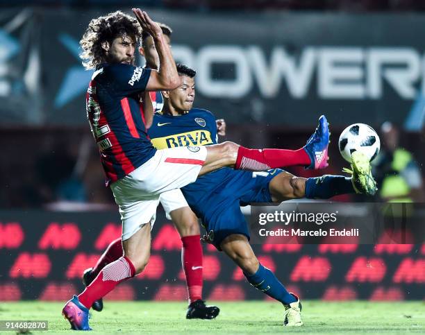 Walter Bou of Boca Juniors fights for ball with Fabricio Coloccini of San Lorenzo during a match between San Lorenzo and Boca Juniors as part of the...