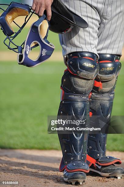 Mike Redmond of the Minnesota Twins holds his catchers mask and helmet during the game against the Detroit Tigers at Comerica Park on October 1, 2009...