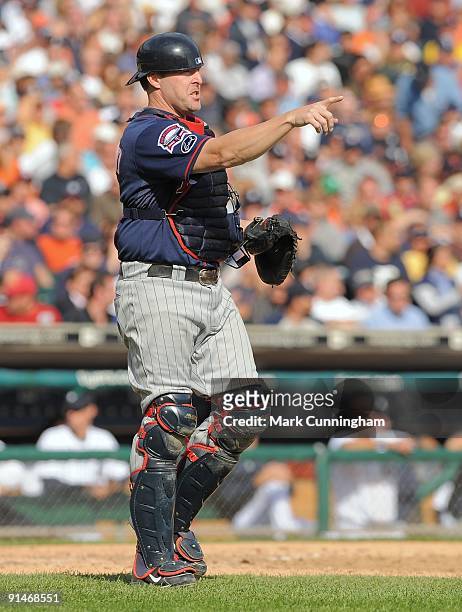 Mike Redmond of the Minnesota Twins looks on and points against the Detroit Tigers during the game at Comerica Park on October 1, 2009 in Detroit,...
