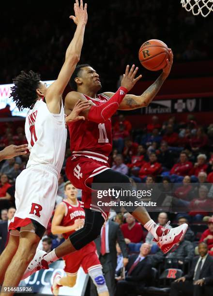 Devonte Green of the Indiana Hoosiers goes up for a shot as Geo Baker of the Rutgers Scarlet Knights defends during the second half of a game at...