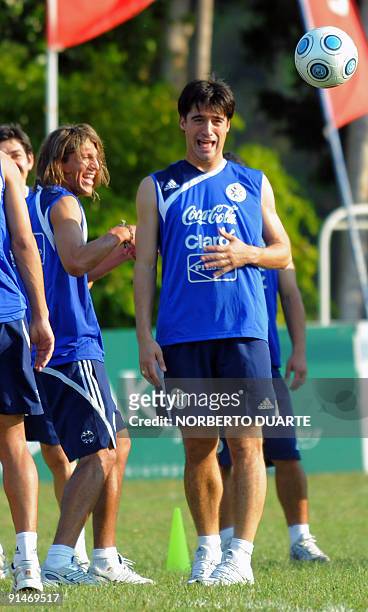 Paraguayan footballer Julio Cesar Caceres jokes with teammates during a training session in Luque, Paraguay, on October 5, 2009. Paraguay will face...