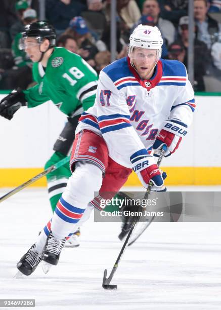 Steven Kampfer of the New York Rangers handles the puck against the Dallas Stars at the American Airlines Center on February 5, 2018 in Dallas, Texas.