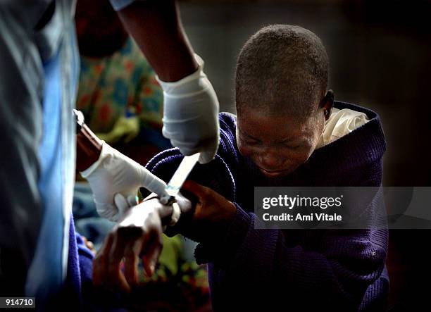 Malawian woman suffering from the HIV virus is treated at the Queen Elizabeth Hospital July 4, 2002 in Blantyre, Malawi. In Malawi, and several other...