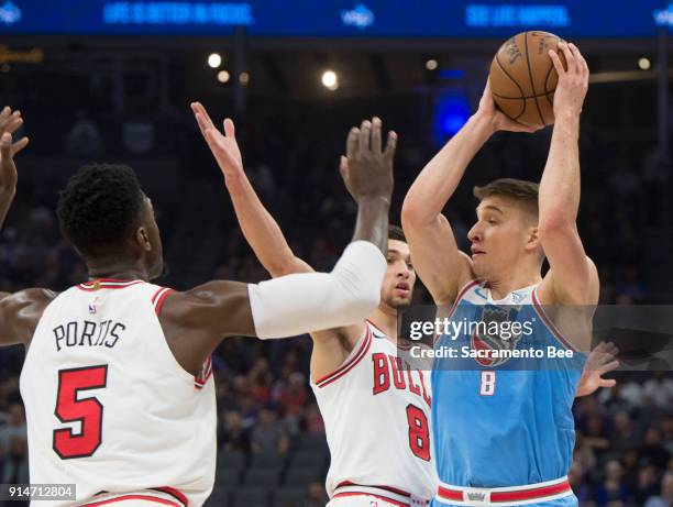 Sacramento Kings guard Bogdan Bogdanovic looks to make a play as he's defended by the Chicago Bulls forward Bobby Portis and Chicago Bulls guard Zach...