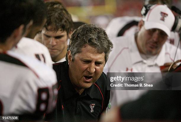 Head coach Mike Leach of the Texas Tech Red Raiders talks with his defense while playing against the University of Houston at Robertson Stadium on...