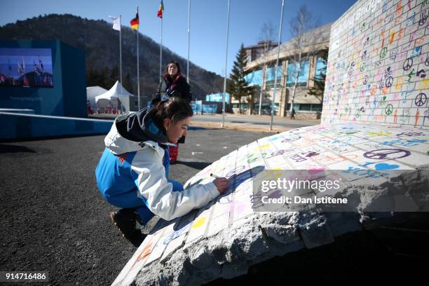 The representative for Moldova signs the Truce Wall after the team's flag raising ceremony during previews ahead of the PyeongChang 2018 Winter...