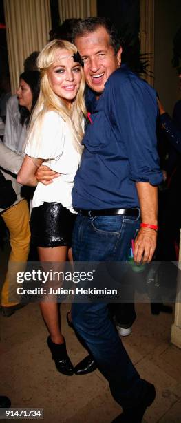 Lindsay Lohan and Mario Testino attend the 'Mario de Janeiro Testino' book launch at Cafe Carmen on October 5, 2009 in Paris, France.