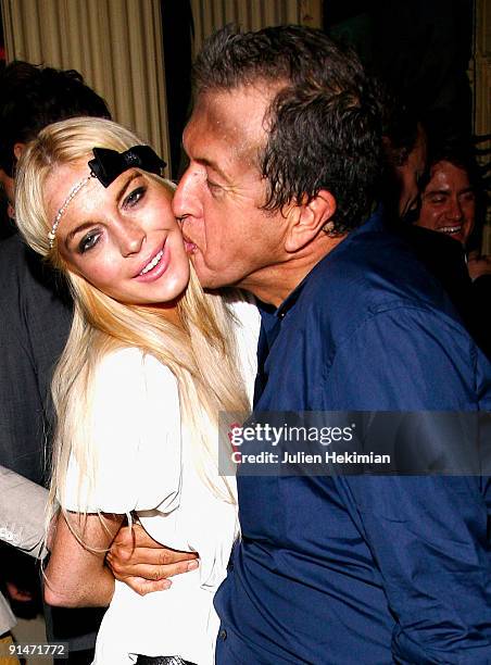 Lindsay Lohan and Mario Testino attend the 'Mario de Janeiro Testino' book launch at Cafe Carmen on October 5, 2009 in Paris, France.