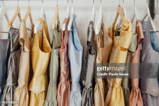 close-up of colorful dress hanging on display at store - ballkleider stock-fotos und bilder