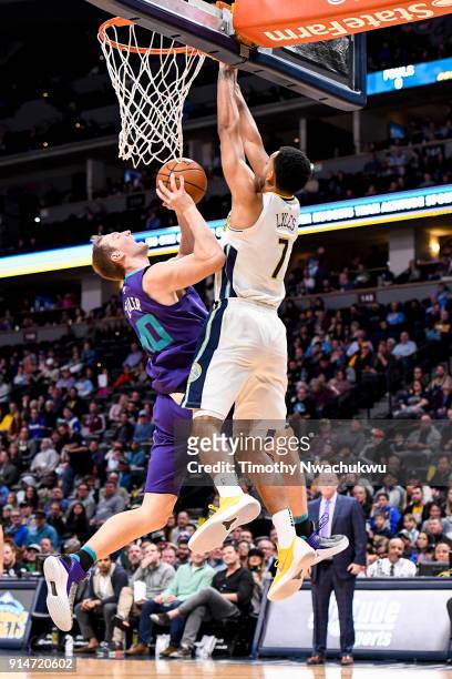 Cody Zeller of the Charlotte Hornets rebounds the ball under Trey Lyles of the Denver Nuggets at the Pepsi Center on February 5, 2018 in Denver,...