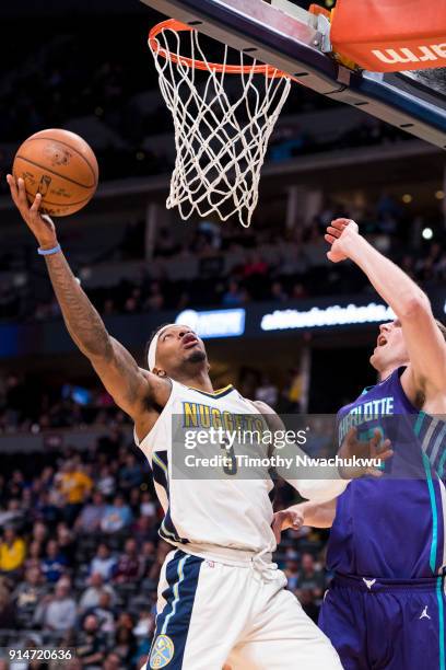 Torrey Craig of the Denver Nuggets goes up for a layup against Cody Zeller of the Charlotte Hornets at the Pepsi Center on February 5, 2018 in...
