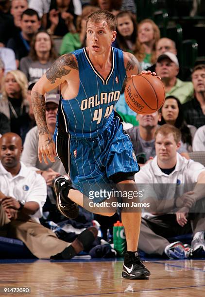 Jason Williams of the Orlando Magic pushes the ball up the court against the Dallas Mavericks in preseason action at the American Airlines Center on...