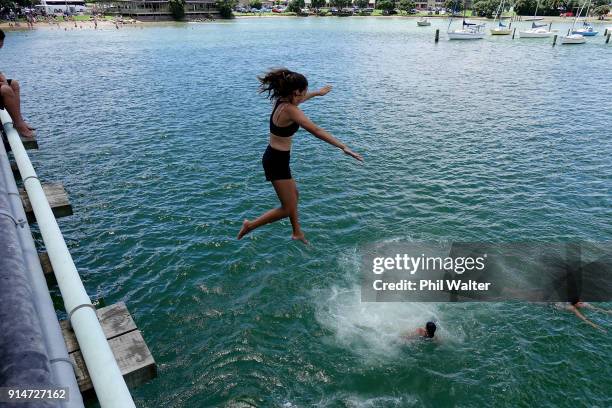 Children jump off the bridge at Te Ti Bay on February 6, 2018 in Waitangi, New Zealand. The Waitangi Day national holiday celebrates the signing of...
